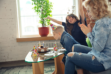 Image showing Mother, son and sister at home having fun, comfort and cozy concept, celebrating birthday