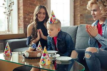 Image showing Mother, son and sister at home having fun, comfort and cozy concept, celebrating birthday