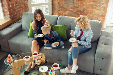 Image showing Mother, son and sister at home having fun, comfort and cozy concept, celebrating birthday