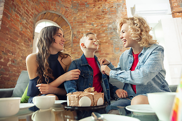 Image showing Mother, son and sister at home having fun, comfort and cozy concept, celebrating birthday