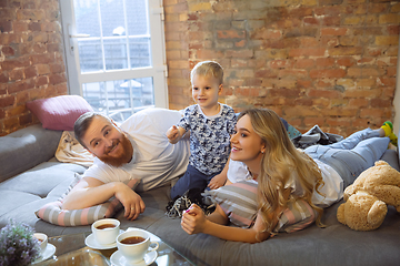 Image showing Mother, father and son at home having fun, comfort and cozy concept