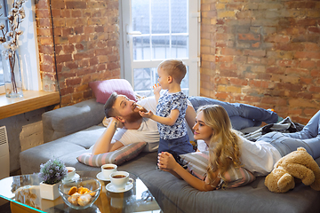 Image showing Mother, father and son at home having fun, comfort and cozy concept