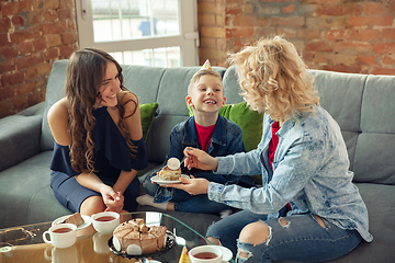 Image showing Mother, son and sister at home having fun, comfort and cozy concept, celebrating birthday