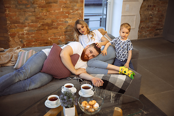 Image showing Mother, father and son at home having fun, comfort and cozy concept