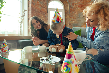 Image showing Mother, son and sister at home having fun, comfort and cozy concept, celebrating birthday