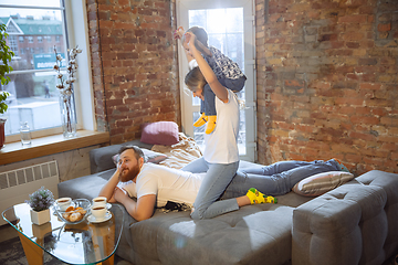 Image showing Mother, father and son at home having fun, comfort and cozy concept