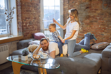 Image showing Mother, father and son at home having fun, comfort and cozy concept