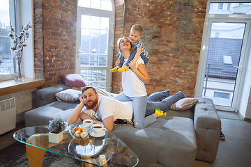 Image showing Mother, father and son at home having fun, comfort and cozy concept