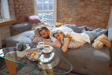 Image showing Mother, father and son at home having fun, comfort and cozy concept