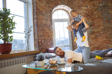 Image showing Mother, father and son at home having fun, comfort and cozy concept