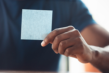 Image showing Close up of african-american male hands, working in office