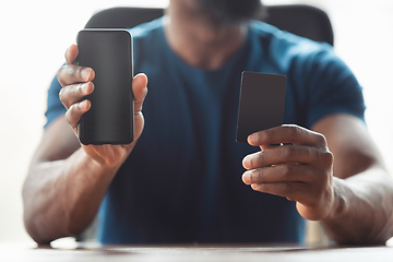 Image showing Close up of african-american male hands, working in office