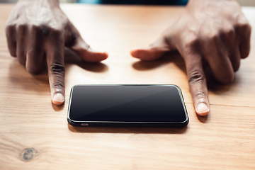 Image showing Close up of african-american male hands, working in office