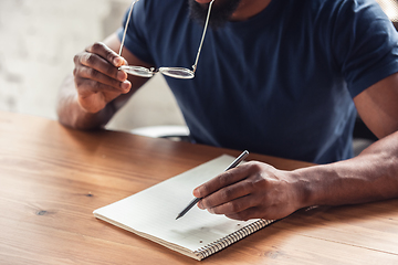 Image showing Close up of african-american male hands, working in office