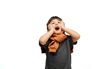 Image showing Happy caucasian little boy isolated on white studio background. Looks happy, cheerful, sincere. Copyspace. Childhood, education, emotions concept