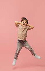 Image showing Happy caucasian little boy isolated on pink studio background. Looks happy, cheerful, sincere. Copyspace. Childhood, education, emotions concept