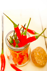 Image showing red chili peppers on a glass jar