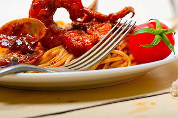 Image showing Italian seafood spaghetti pasta on red tomato sauce