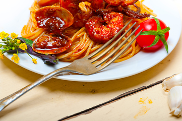 Image showing Italian seafood spaghetti pasta on red tomato sauce