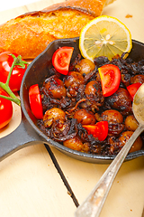 Image showing Baby cuttle fish roasted on iron skillet