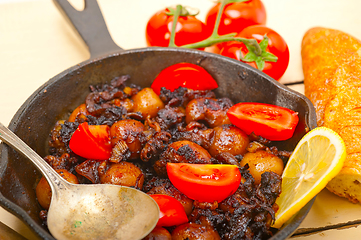 Image showing Baby cuttle fish roasted on iron skillet