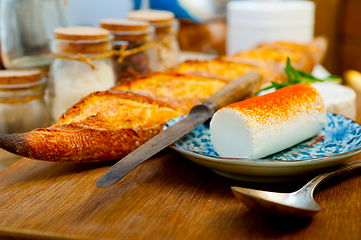 Image showing French cheese and fresh  baguette on a wood cutter