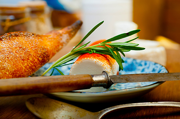 Image showing French cheese and fresh  baguette on a wood cutter