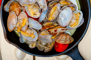 Image showing fresh clams on an iron skillet