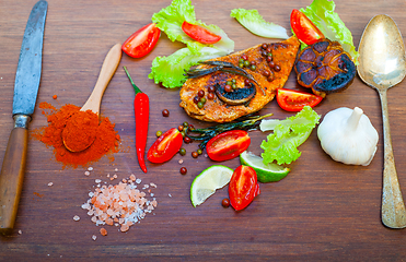 Image showing wood fired hoven cooked chicken breast on wood board