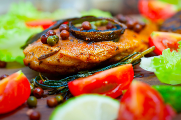 Image showing wood fired hoven cooked chicken breast on wood board