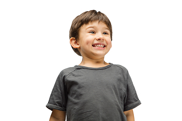 Image showing Happy caucasian little boy isolated on white studio background. Looks happy, cheerful, sincere. Copyspace. Childhood, education, emotions concept