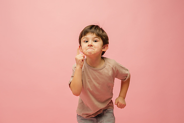 Image showing Happy caucasian little boy isolated on pink studio background. Looks happy, cheerful, sincere. Copyspace. Childhood, education, emotions concept