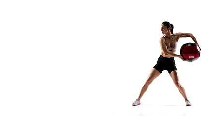 Image showing Caucasian professional female athlete training isolated on white studio background. Muscular, sportive woman.