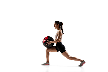 Image showing Caucasian professional female athlete training isolated on white studio background. Muscular, sportive woman.