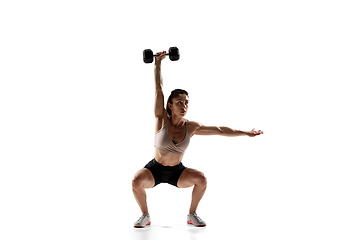 Image showing Caucasian professional female athlete training isolated on white studio background. Muscular, sportive woman.