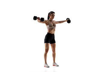 Image showing Caucasian professional female athlete training isolated on white studio background. Muscular, sportive woman.