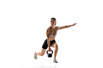 Image showing Caucasian professional female athlete training isolated on white studio background. Muscular, sportive woman.