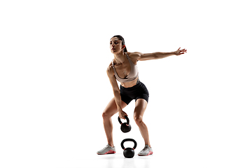 Image showing Caucasian professional female athlete training isolated on white studio background. Muscular, sportive woman.