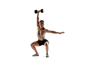 Image showing Caucasian professional female athlete training isolated on white studio background. Muscular, sportive woman.