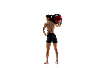 Image showing Caucasian professional female athlete training isolated on white studio background. Muscular, sportive woman.