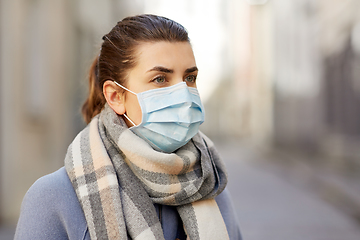 Image showing young woman wearing protective medical mask