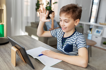 Image showing boy having video calll on tablet pc at home