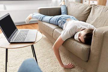 Image showing sick bored woman with laptop lying on sofa at home