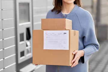 Image showing woman with boxes at automated parcel machine