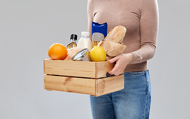 Image showing close up of woman with food in wooden box