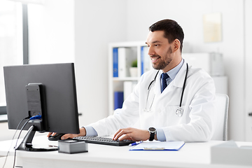 Image showing male doctor with computer working at hospital