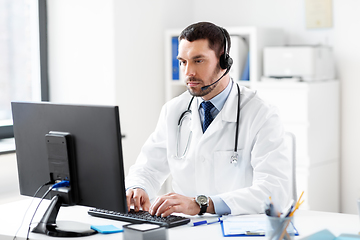 Image showing male doctor with computer and headset at hospital