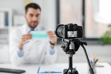 Image showing doctor with mask recording video blog at hospital