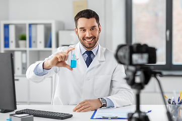 Image showing doctor with hand sanitizer recording video blog