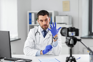 Image showing male doctor with gloves recording video blog